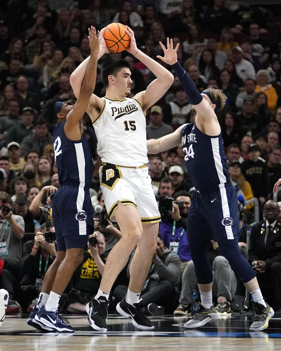 CORRECTS DAY/DATE TO SUNDAY, MARCH 12 INSTEAD OF SATURDAY, MARCH 11 - Purdue's Zach Edey (15) looks to pass as Penn State's Jalen Pickett (22) and Michael Henn defend during the first half of an NCAA college basketball championship game at the Big Ten men's tournament, Sunday, March 12, 2023, in Chicago. (AP Photo/Nam Y. Huh)