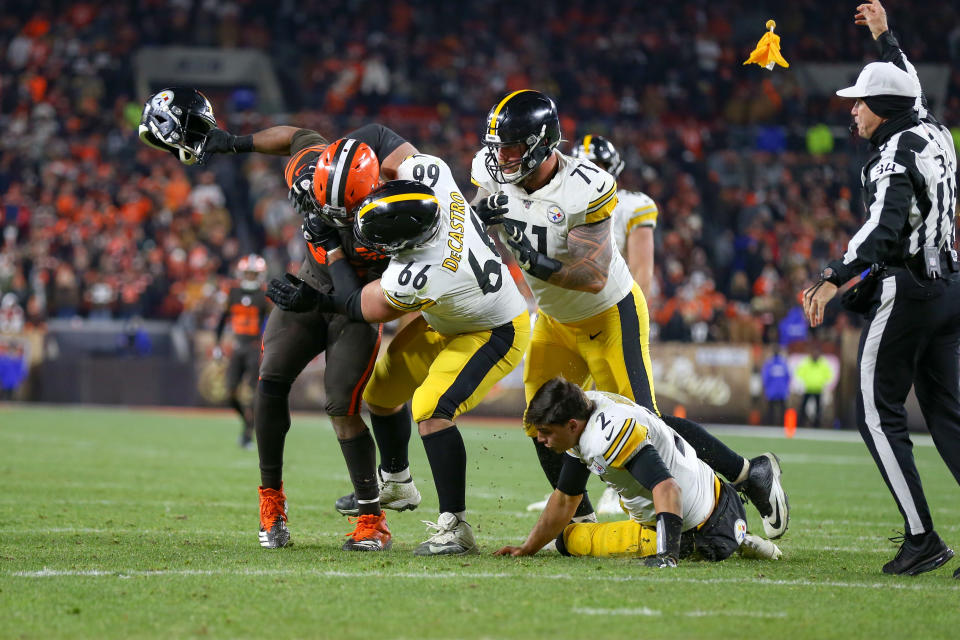 CLEVELAND, OH - NOVEMBER 14: Referee Clete Blakeman (34) throws a flag as Cleveland Browns defensive end Myles Garrett (95) swings the helmet of Pittsburgh Steelers quarterback Mason Rudolph (2) as Pittsburgh Steelers offensive guard David DeCastro (66) and Pittsburgh Steelers offensive tackle Matt Feiler (71) battle Garrett during the fourth quarter of the National Football League game between the Pittsburgh Steelers and Cleveland Browns on November 14, 2019, at FirstEnergy Stadium in Cleveland, OH. (Photo by Frank Jansky/Icon Sportswire via Getty Images)