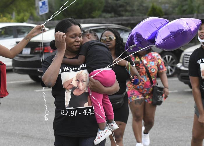 Loved ones gathering for a memorial for Jaida Peterson wear a T-shirt with her photo on it April 9, 2021, at Tuckaseegee Park in Charlotte, North Carolina.