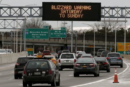 An electronic sign displays a blizzard warning over the Grand Central Parkway near New York's Laguardia Airport in the Queens borough of New York City, January 22, 2016, as a winter storm approaches. REUTERS/Mike Segar