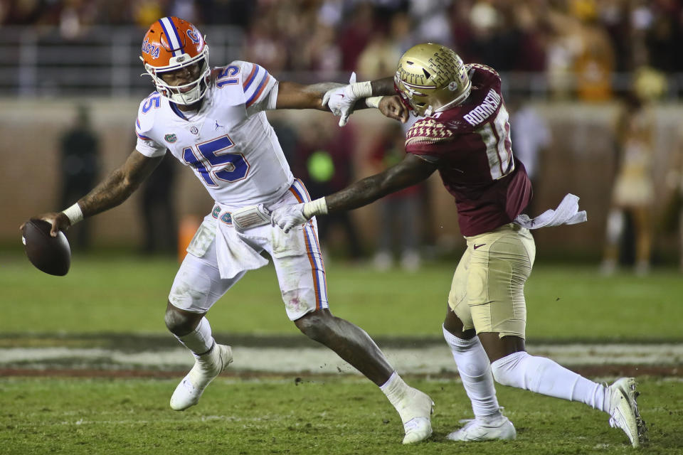 Florida quarterback Anthony Richardson (15) is pressured by Florida State defensive back Jammie Robinson (10) before Richardson threw an incomplete pass on the last play of an NCAA college football game Friday, Nov. 25, 2022, in Tallahassee, Fla. Florida State won 45-38. (AP Photo/Phil Sears)