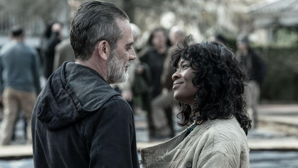 Negan and Annie face each other and smile in the walking dead 