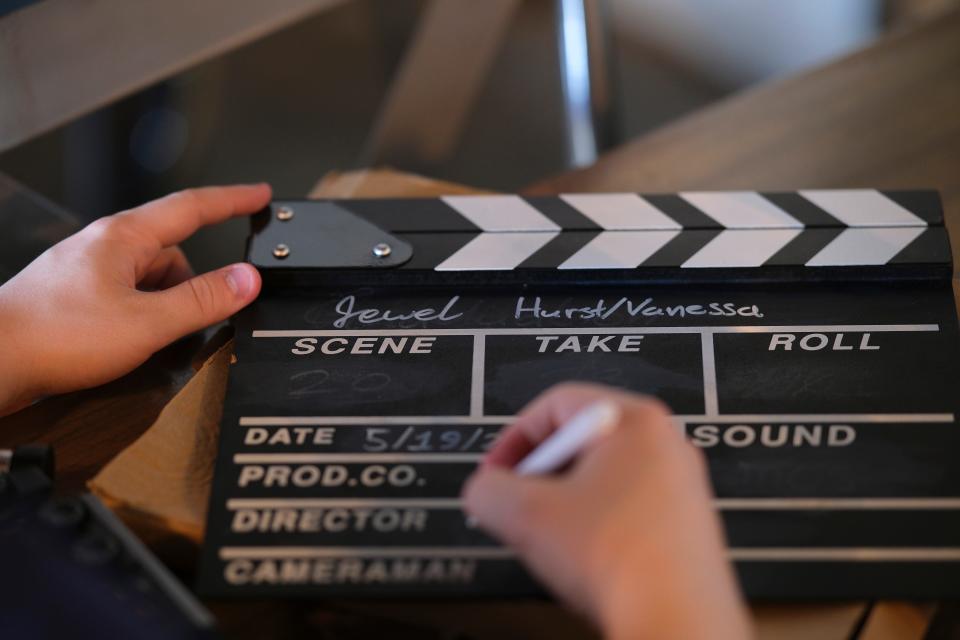 A crew member writes on the clapperboard during filming on the upcoming documentary "The Jewel" at Florence's Restaurant.