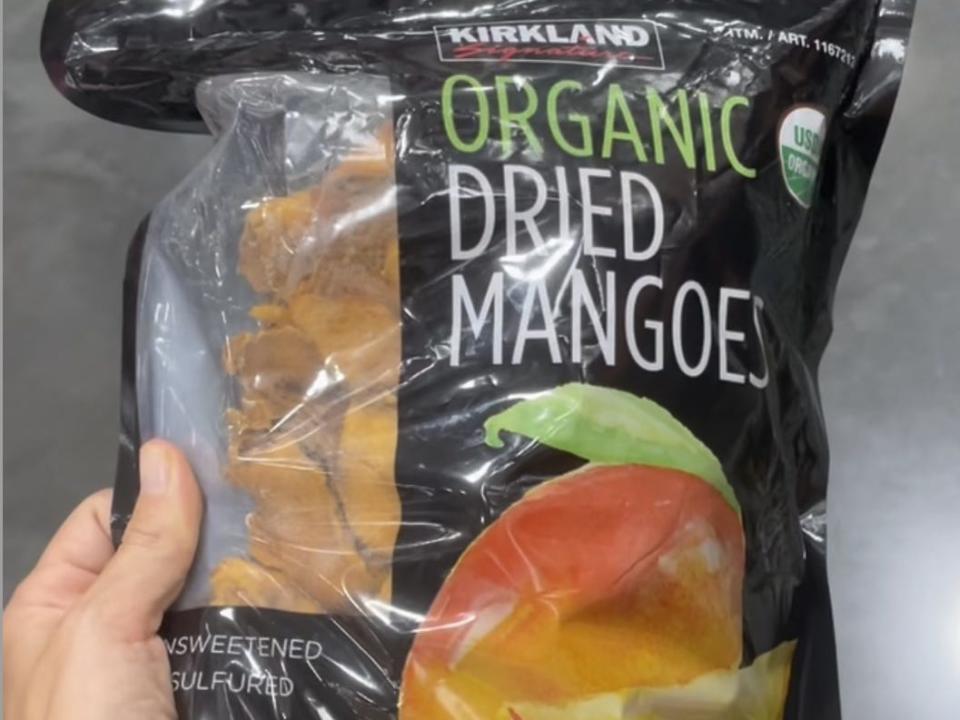 hand holding bag of dried mangoes at costco