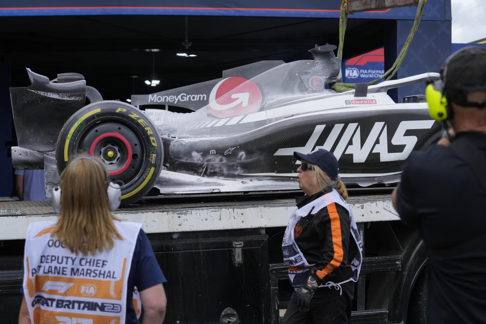 The car of Haas driver Kevin Magnussen of Denmark is towed during the British Formula One Grand Prix race at the Silverstone racetrack, Silverstone, England, Sunday, July 9, 2023. (AP Photo/Luca Bruno)