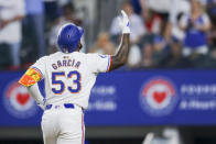 Texas Rangers' Adolis Garcia celebrates his two-run home run against the Chicago Cubs during the third inning of a baseball game Saturday, March 30, 2024 in Arlington, Texas. (AP Photo/Gareth Patterson)