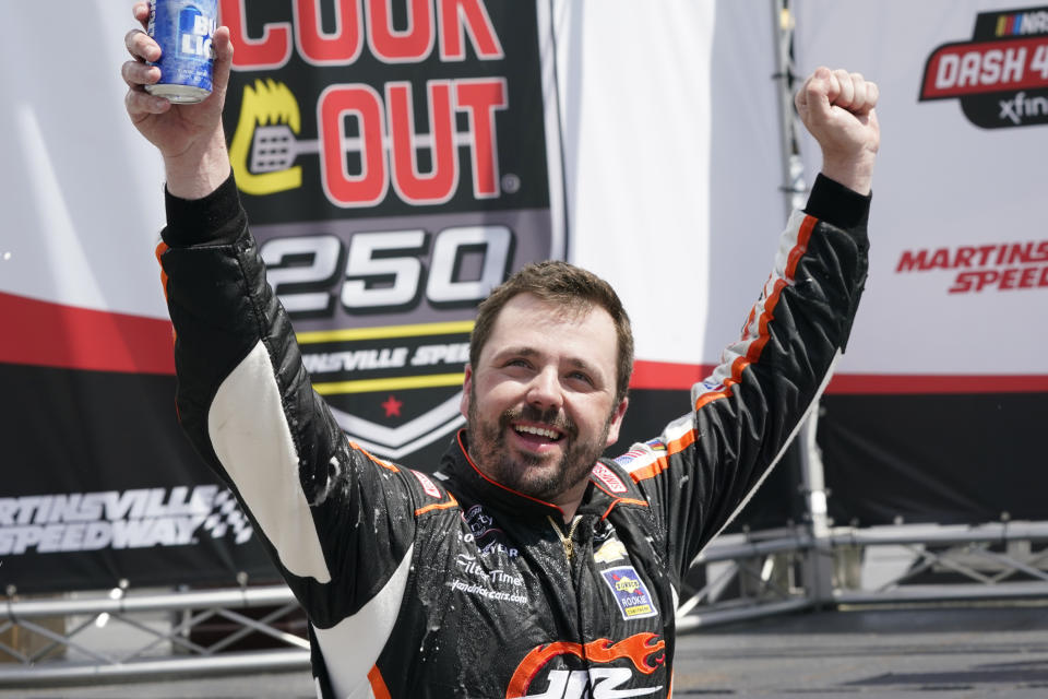 Josh Berry celebrates winning the rain delayed NASCAR Xfinity Series auto race at Martinsville Speedway in Martinsville, Va., Sunday, April 11, 2021. (AP Photo/Steve Helber)