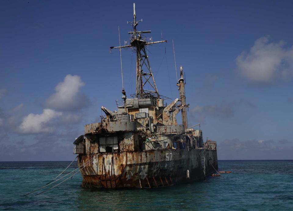 A dilapidated Philippine Navy ship LT 57 (Sierra Madre) with Philippine troops deployed on board is anchored off Second Thomas Shoal, locally known as Ayungin Shoal, Sunday, March 30, 2014 off South China Sea. On Saturday, China Coast Guard attempted to block the Philippine government vessel AM700 carrying fresh troops and supplies, but the latter successfully managed to docked beside the ship to replace troops who were deployed for five months. (AP Photo/Bullit Marquez)