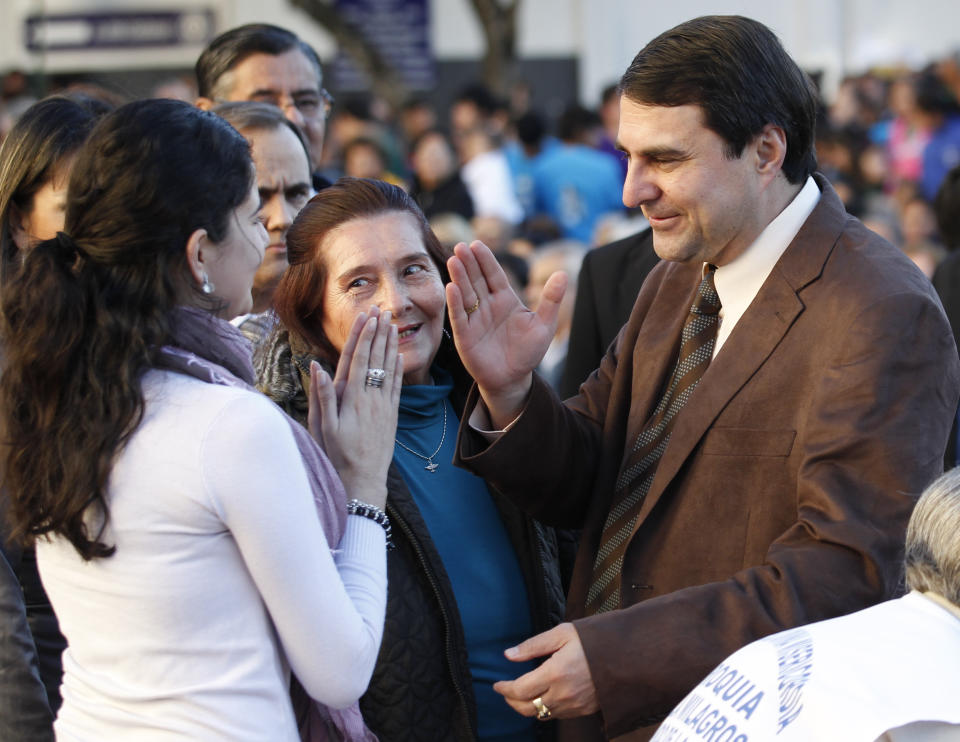 Paraguay's new President Federico Franco blesses a youth during a Mass outside the Cathedral in Asuncion, Paraguay, Saturday, June 23, 2012. Former President Fernando Lugo's ouster by lawmakers on Friday has been widely condemned in Latin America as Franco is promising to honor foreign commitments and reach out to Latin American leaders to try to keep his country from becoming a regional pariah. (AP Photo/Jorge Saenz)