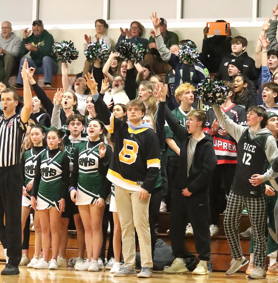 The Rice student section reacts to a big three-point basket during the Green Knights' 79-64 win over St. Johnsbury on Thursday night at RHS.