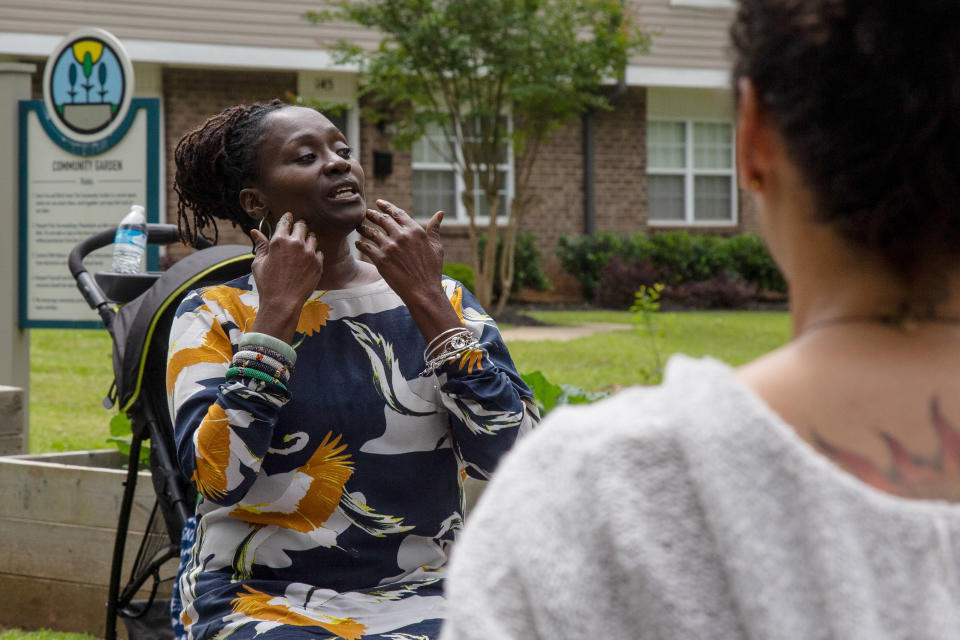 Jamilah Shakir, left, leads a group of women through yoga excercises on Wednesday, April 29, 2020, in Atlanta. Shakir says her family and friends have chosen to respect social distancing during Ramadan. Like many Muslims this year, she will also be missing the special Ramadan taraweeh prayers at the mosque and the imam reciting verses from the Quran. But she looks for the blessings. (AP Photo/Ron Harris)