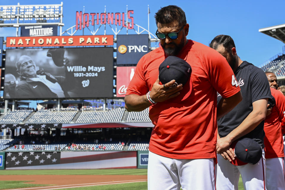 Washington Nationals manager Dave Martinez bows his head during a moment of silence in observance of the death of Baseball Hall of Fame Willie Mays before a baseball game against the Arizona Diamondbacks Wednesday, June 19, 2024, in Washington. (AP Photo/John McDonnell)