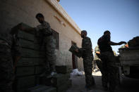 <p>Syrian Democratic Forces (SDF) fighters unload boxes of ammunition near Raqqa city, Syria June 7, 2017. (Photo: Rodi Said/Reuters) </p>