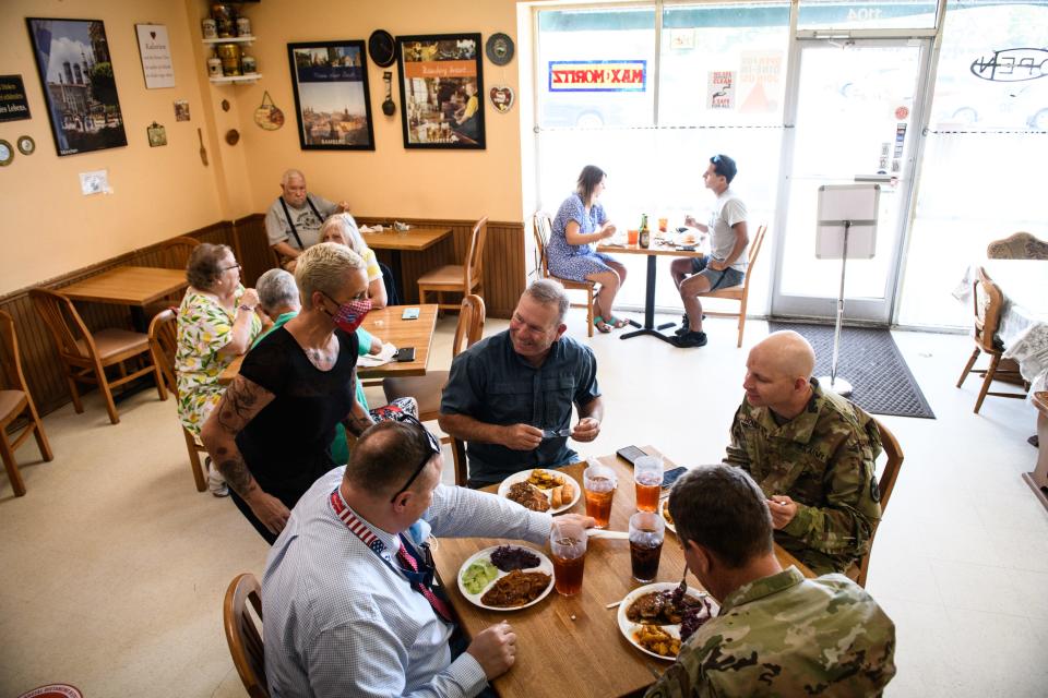 Customers sit down to eat at Max & Moritz in the Cliffdale Square shopping plaza on Wednesday, May 5, 2021.