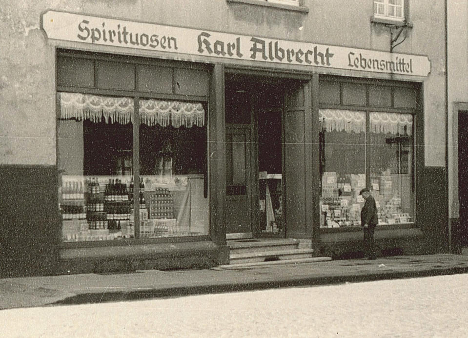 The image, dated 1930, of a general outside view of Karl Albrecht Spiritousen and Lebensmittel shop in Germany.  Source: Getty