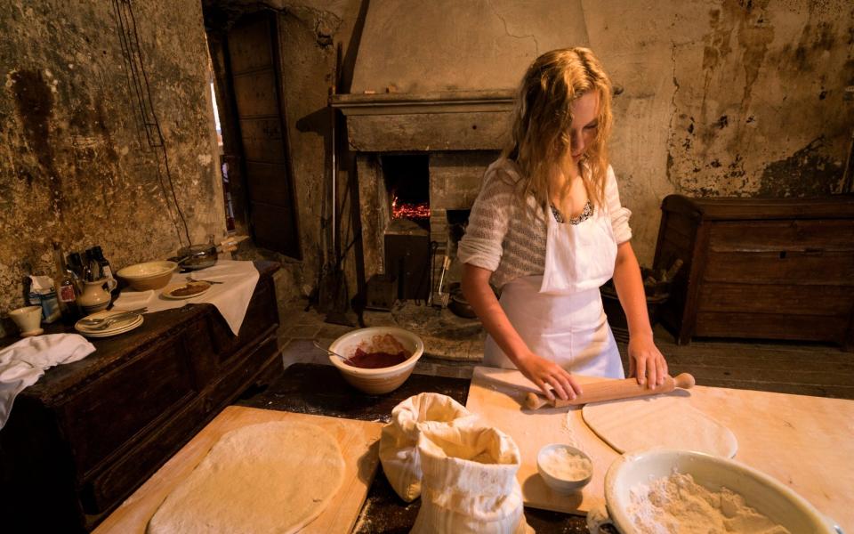 Teenage girl rolls out dough in Abruzzo - Getty/E+