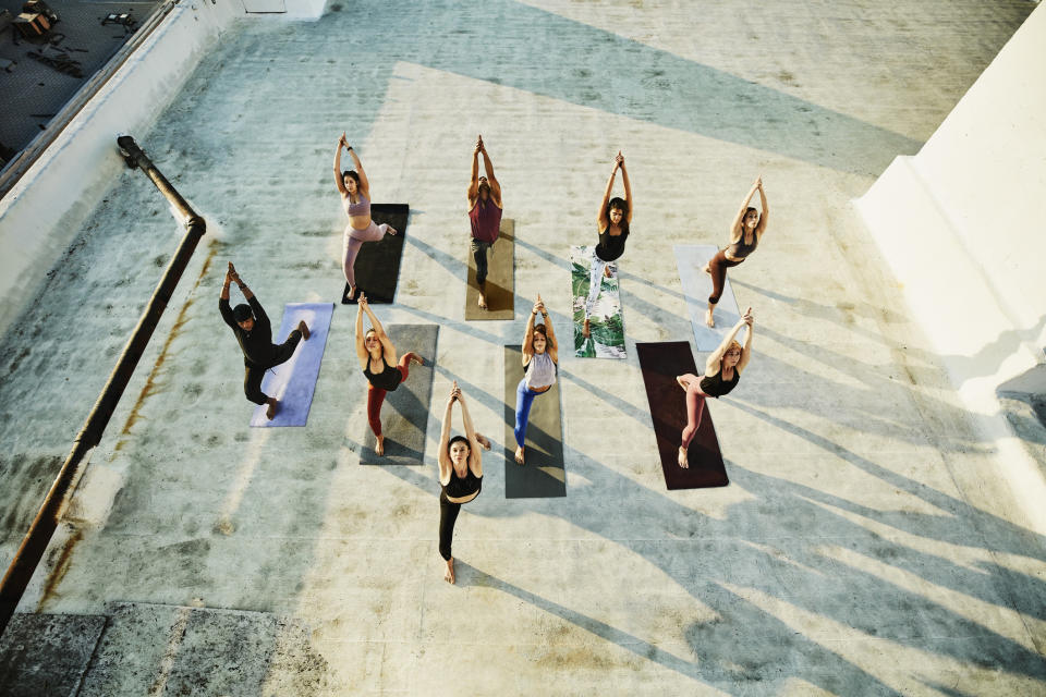 A group of people doing yoga from an aerial view.