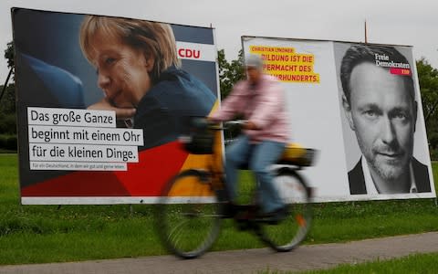 Election campaign posters show German Chancellor Angela Merkel, a top candidate of the Christian Democratic Union Party (CDU) and the leader of the liberal Free Democratic Party (FDP) Christian Lindner in Ribnitz-Damgarten, Germany - Credit: REUTERS/Fabrizio Bensch