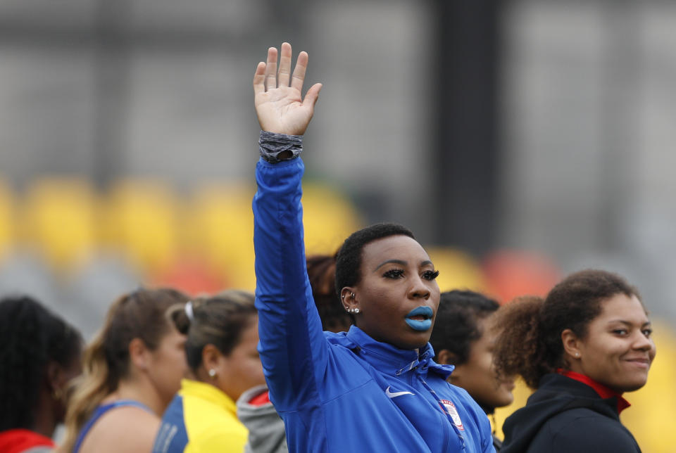 FILE - In this Aug. 10, 2019, file photo, Gwendolyn "Gwen" Berry of the United States waves as she is introduced at the start of the women's hammer throw final, during athletics competition at the Pan American Games in Lima, Peru. Berry won the gold medal. The U.S. Olympic and Paralympic Committee is signaling willingness to challenge longstanding IOC rules restricting protests at the Olympics, while also facing backlash from some of its own athletes for moves viewed by some as not being driven by sufficient athlete input. (AP Photo/Rebecca Blackwell, File)