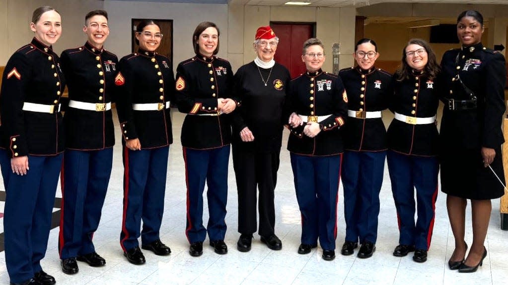 Mildred "Millie" Cox with members of the Parris Island Marine Band when it visited North Quincy High School in March, 2024.