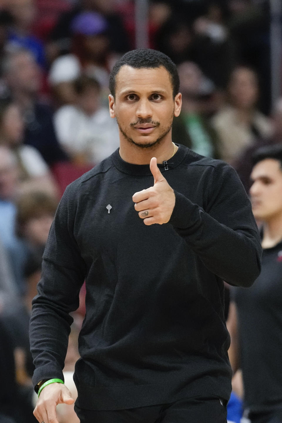 Boston Celtics head coach Joe Mazzulla gives a thumbs-up during the first half of an NBA basketball game against the Miami Heat, Sunday, Feb. 11, 2024, in Miami. (AP Photo/Rebecca Blackwell)