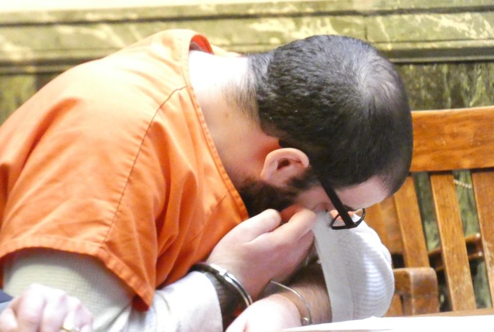 Cameron Davis, 32, Crestline, wipes his eyes after addressing the family of Michael “Mikey” Benedict in Crawford County Common Pleas Court.