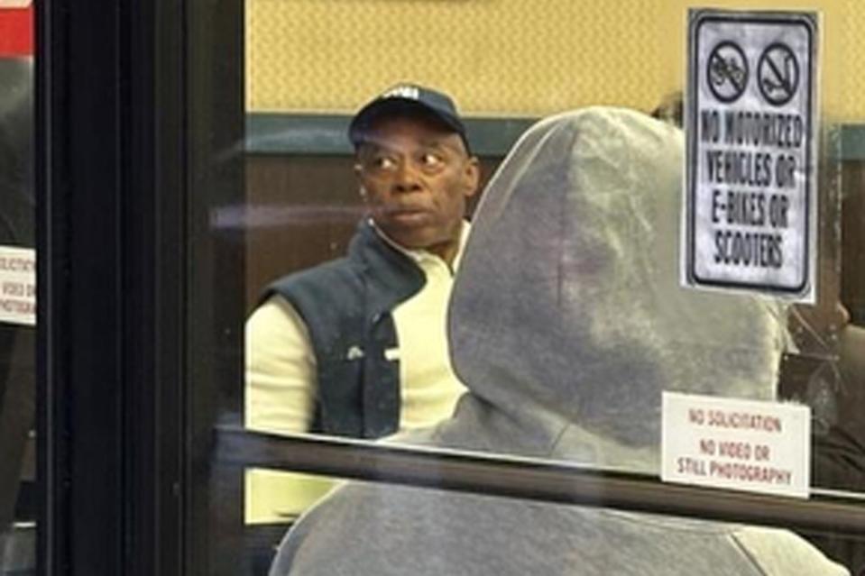 Mayor Eric Adams sitting inside the Burger King, where a witness said he met for an hour with the group that stands outside the Burger King.