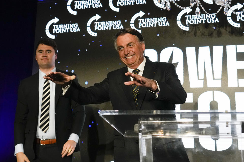 Brazil's right wing former President Jair Bolsonaro, right, speaks alongside Turning Point USA founder Charlie Kirk, at a TPUSA event at Trump National Doral Miami, Friday, Feb. 3, 2023, in Doral, Fla. (AP Photo/Rebecca Blackwell)