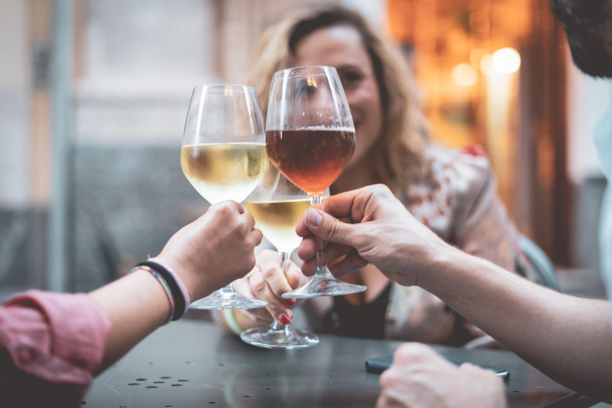 Friends drinking wine to highlight dangers of binge drinking 