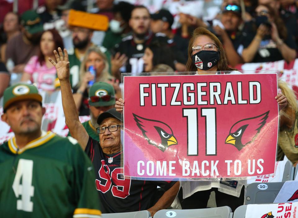 Arizona Cardinals fans hold a sign for former wide receiver Larry Fitzgerald before their game against the Green Bay Packers in Glendale, Ariz. Oct. 28, 2021.