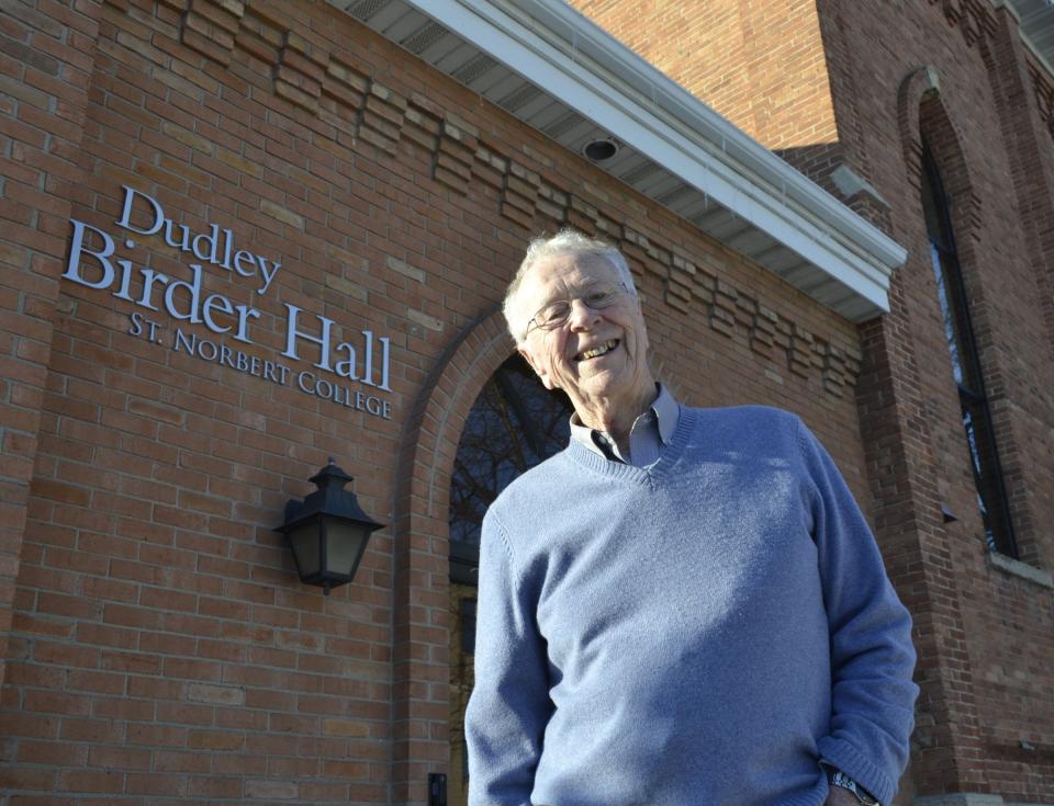 Dudley Birder, who has worked at St. Norbert College as a music teacher and director since 1958, stands outside Dudley Birder Hall at the corner of Grant and Fourth streets in De Pere.