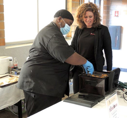 The team from The Farmouse of Zeeland work on the winning dish at the "Farms are the Tapas" fundraiser and cooking competition Thursday, Sept. 30, 2021.