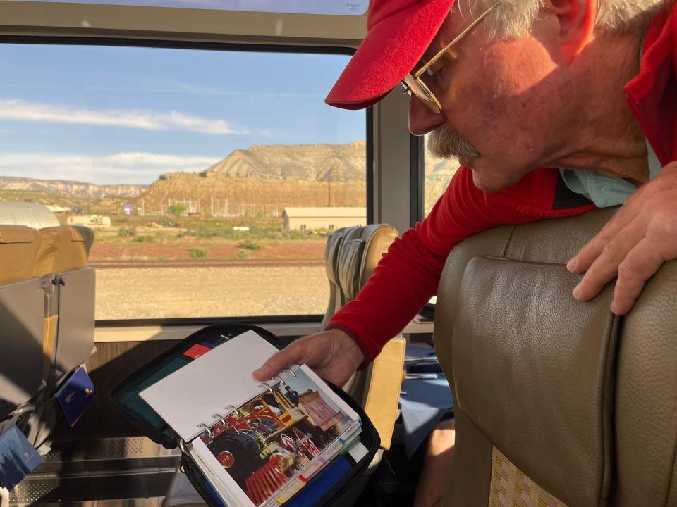 Tom Haraden shows off an old picture of himself working in the national parks.