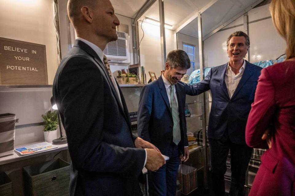 Gov. Gavin Newsom, right, San José Mayor Matt Mahan, center, and Assemblymember Kevin McCarty, left, tour a tiny home Thursday after Newsom announced the state will have 1,200 tiny homes built and delivered throughout California in an effort to help house the homeless population. Renée C. Byer/rbyer@sacbee.com