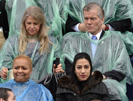 Huma Abedin (front R), aide to Hillary Clinton and wife of former U.S. congressman Anthony Weiner, awaits the start of the swearing-in ceremony of Terry McAuliffe as Virginia's governor, along with outgoing Virginia Governor Bob McDonnell (back R) and his wife Maureen, in Richmond, Virginia, January 11, 2014. REUTERS/Mike Theiler