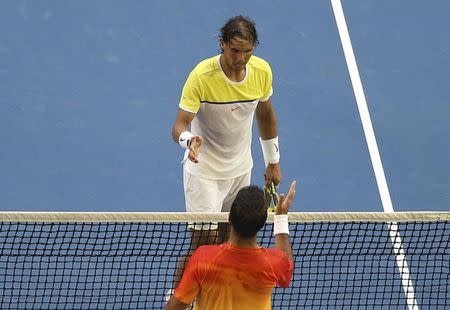 Spain's Rafael Nadal (top) shakes hands with Spain's Fernando Verdasco after Verdasco won their first round match at the Australian Open tennis tournament at Melbourne Park, Australia, January 19, 2016. REUTERS/Jason O'Brien