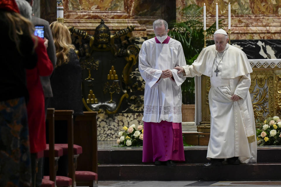 Master of Pontifical Liturgical Ceremonies, Italian priest Guido Marini helps Pope Francis step down after he delivered his Urbi et Orbi Blessing, after celebrating Easter Mass at St. Peter's Basilica at The Vatican Sunday, April 4, 2021, during the Covid-19 coronavirus pandemic. (Filippo Monteforte/Pool photo via AP)