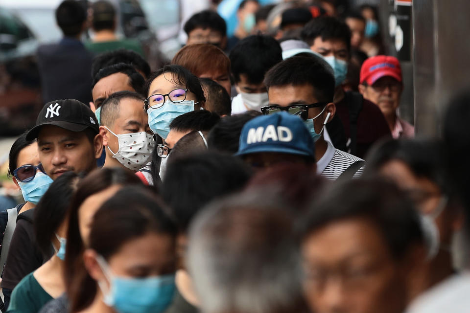 SINGAPORE - FEBRUARY 08:  People queue to buy protective masks at Mustafa Centre on February 8, 2020 in Singapore. Yesterday, Singapore raised its coronavirus outbreak alert to orange prompting many residents to put on masks with the World Health Organisation chief warned of a global shortage of masks and other protective equipment to fight against the novel coronavirus.  (Photo by Suhaimi Abdullah/Getty Images)