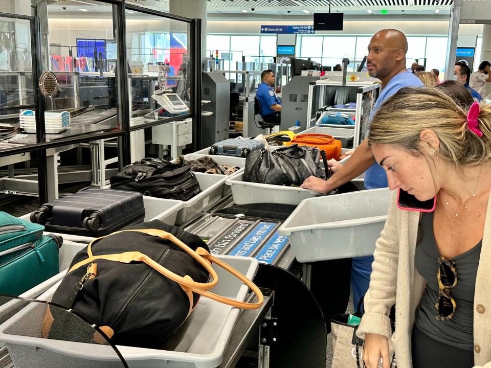 Passengers loading their belongings into bins at the automated screening lanes at Los Angeles International Airport.