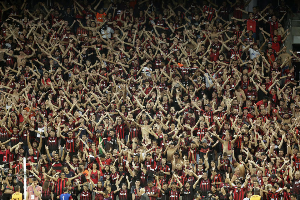 Fans of Brazil's Atletico Paranaense cheer prior to the Copa Sudamericana final soccer match against Colombia's Junior in Curitiba, Brazil, Wednesday, Dec. 12, 2018. Paranaense won the title after a penalty kick shoot-out. (AP Photo/Victor Caivano)