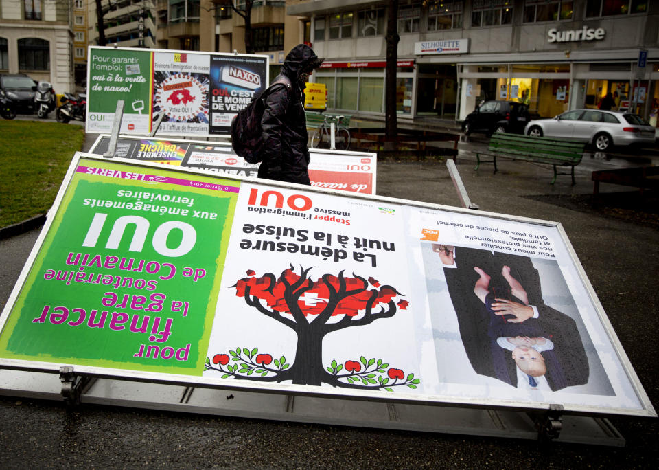 A man passes by election posters demanding a stop for immigration to Switzerland in the center of Geneva, Switzerland, Monday, Feb. 10, 2014. The placard in the center foreground reads ' excess harms Switzerland'. The choice by Swiss voters to reimpose curbs on immigration is sending shockwaves throughout the European Union, with EU leaders on Monday warning the Swiss had violated the “sacred principle” of Europeans’ freedom of movement and politicians anxiously trying to gauge the vote’s impact on burgeoning anti-foreigner movements in other countries. (AP Photo/Anja Niedringhaus)