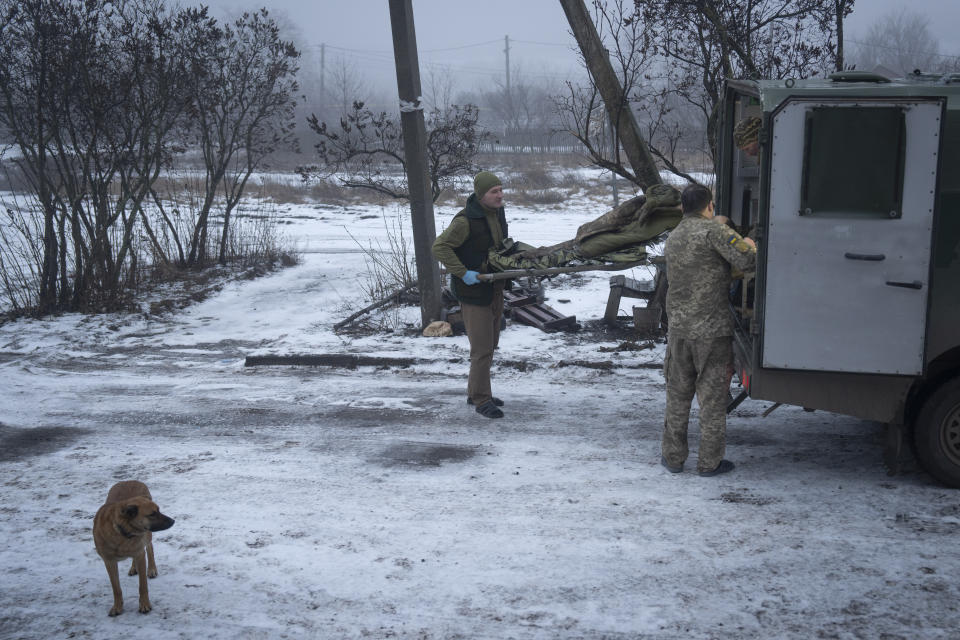 Ukrainian soldiers carry their wounded fellow at a medical stabilisation point near Bakhmut, Donetsk region, Ukraine, Friday, Jan. 26, 2024. (AP Photo/Efrem Lukatsky)