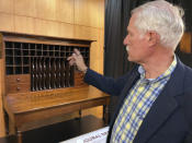 Robin DeGroot, a conservator for Third Coast Conservation in Elmhurst, explains the nuanced work he did on cubby holes in the desk that Abraham Lincoln used to draft the presidential inaugural address Thursday, Sept. 16, 2021 in Springfield, Ill.. The desk that Abraham Lincoln used to draft the presidential inaugural address he delivered on March 4, 1861, on the eve of the Civil War, is on display free to the public. Lincoln needed a quiet place away from well-wishers to write the speech, and his brother-in-law, Clark Moulton Smith, offered him a third-floor storage room in the store he owned on the state Capitol square in downtown Springfield. The state purchased the desk from the Smith family in 1953 and this summer spent $6,300 to have it historically restored and repaired. (AP Photo/John O'Connor)