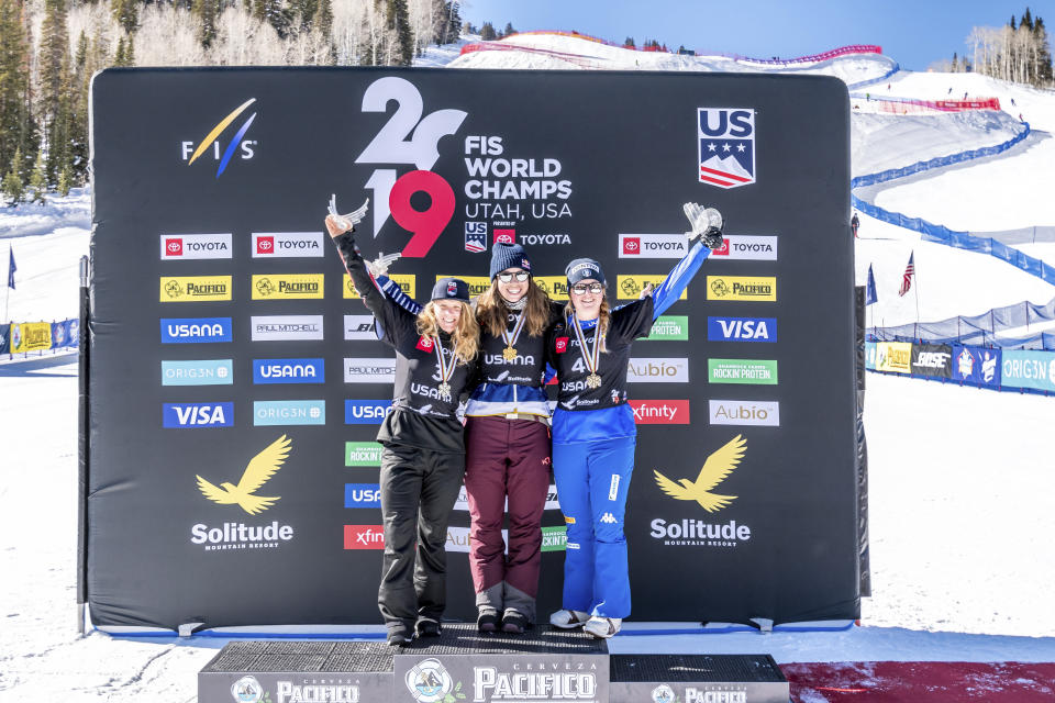 Silver medalist Charlotte Bankes, left, of Great Britain, gold medalist Eva Samkova, center, of the Czech Republic, and bronze medalist Michela Moioli, of Italy celebrate o the podium after the the women's snowboard cross final at the Freestyle Ski and Snowboard World Championships, Friday, Feb. 1, 2019, in Solitude, Utah. (AP Photo/Tyler Tate)