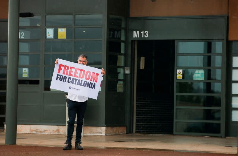 FILE PHOTO: Catalan leader Jordi Cuixart holds a banner in front of the Lledoners prison after the Spanish government announced a pardon for those who participated in Catalonia's failed 2017 independence bid, Sant Joan de Vilatorrada, near Barcelona