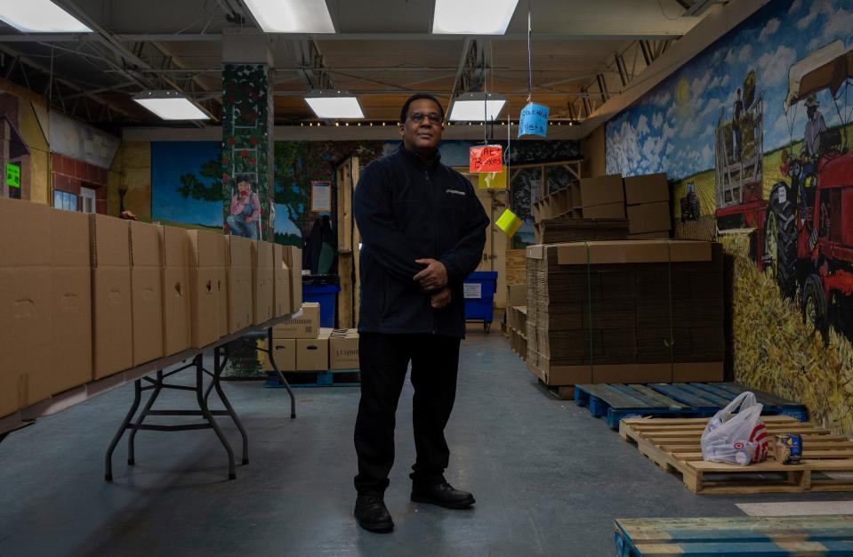 Russell Estill, director of food programs at Lighthouse of Oakland County, stands in a room that has empty boxes and wooden pallets inside an emergency food warehouse run by Lighthouse, a nonprofit in Pontiac, on Wednesday, Jan. 24, 2024.