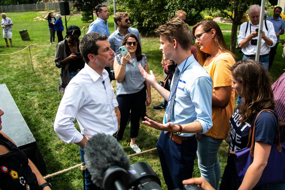 Democratic presidential candidate Pete Buttigieg, mayor of South Bend, Indiana, talks with Nick Roberts, 19, of Indianapolis, at a campaign event, Wednesday, Aug. 14, 2019, at a home in Muscatine, Iowa. Roberts drove ten hours from Indiana to see Buttigieg, on his 19th birthday.