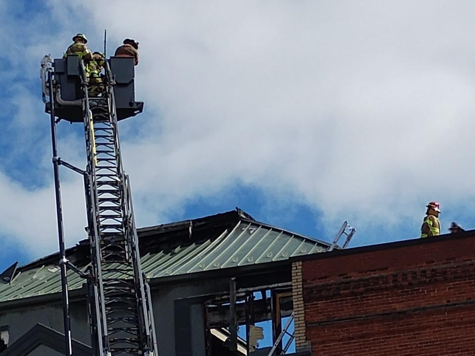 Fire crews returned to the building around noon Sunday to extinguish hot spots.
