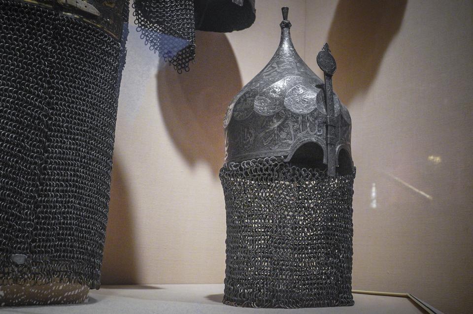 A Turkish multi-metal head armor, "Helmet with Aventail"—an anonymous gift made in 1950 to the Metropolitan Museum of Art—is shown on exhibition at the museum Thursday, Sept. 1, 2022, in New York. The armor is among 53 works in the museum's collection, once looted during the Nazi era, but returned to their designated owners before being obtained by the museum through donation or sale. (AP Photo/Bebeto Matthews)