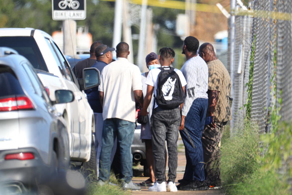 Family members of victims and employees pray outside of a post office after a shooting, Tuesday, Oct. 12, 2021 in the Orange Mound neighborhood of Memphis, Tenn. Police investigated a shooting Tuesday at a post office in an historic neighborhood of Memphis, Tennessee, the third high-profile shooting in the region in weeks.(Patrick Lantrip/Daily Memphian via AP)